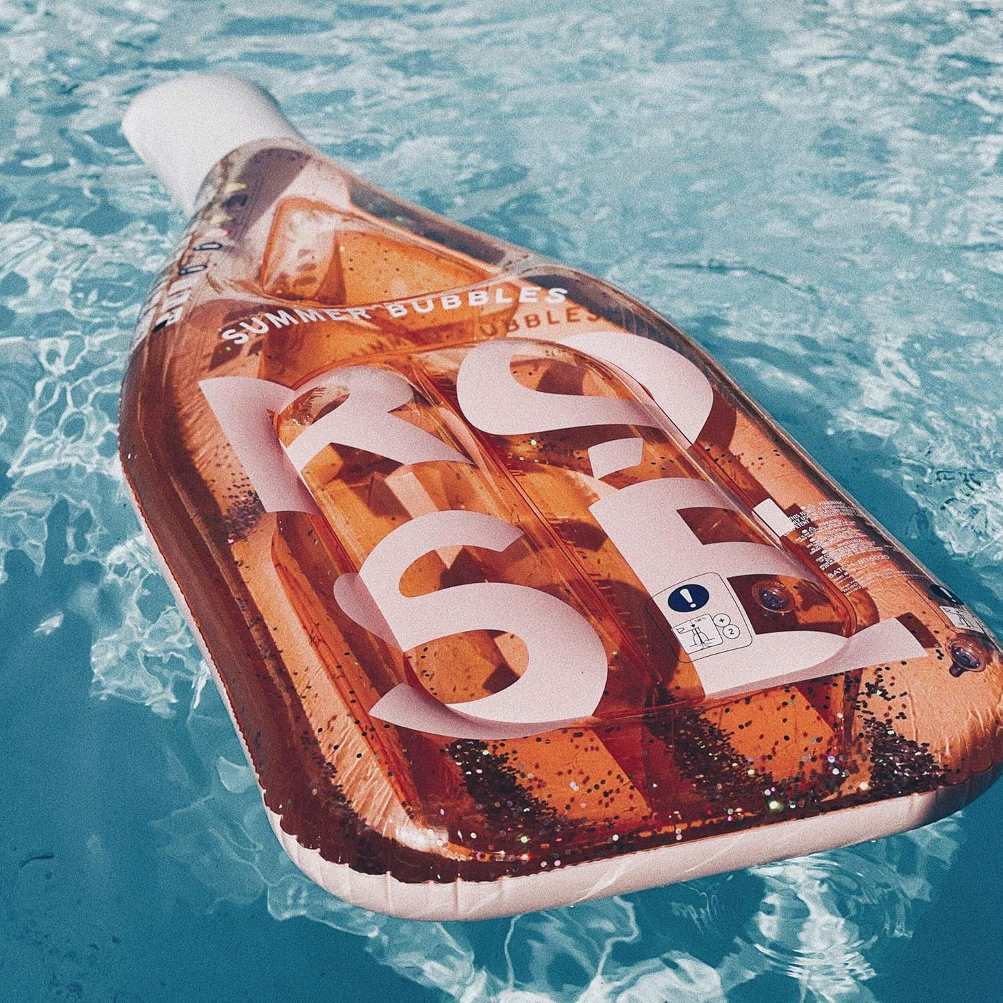 SunnyLIFE Luxe Lie-On Inflatable Rose Bottle Float